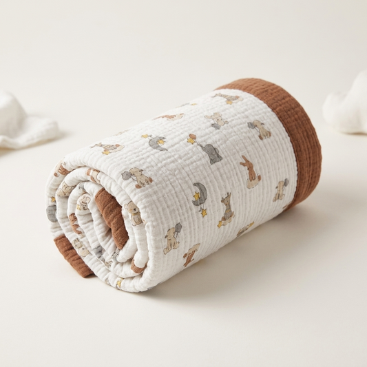 Organic 4-layer
muslin baby blanket
with animal pattern
in white and camel brown
by Baby DukWear Inc.