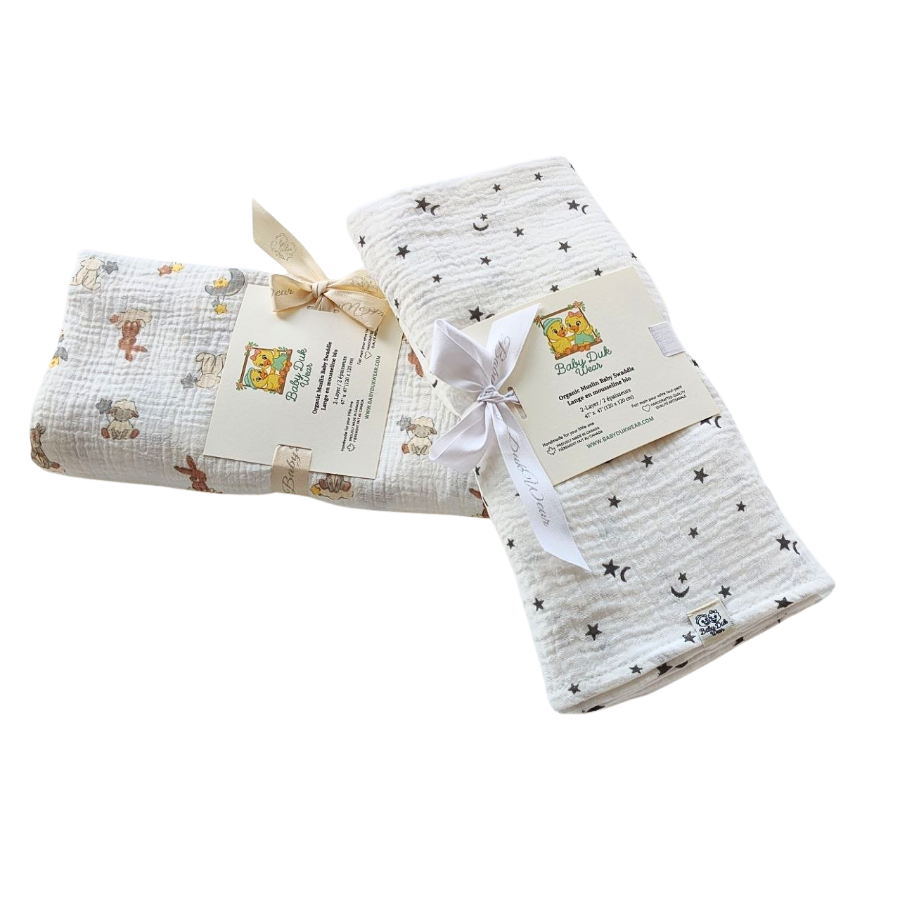 Two folded muslin swaddle blankets from Baby Einstein's 'My First Space & Nature' collection, one with a space-themed star and moon pattern and one with a nature-themed animal print Northern Stars and pattern Dream , both tied with ribbons and attached to product tags.