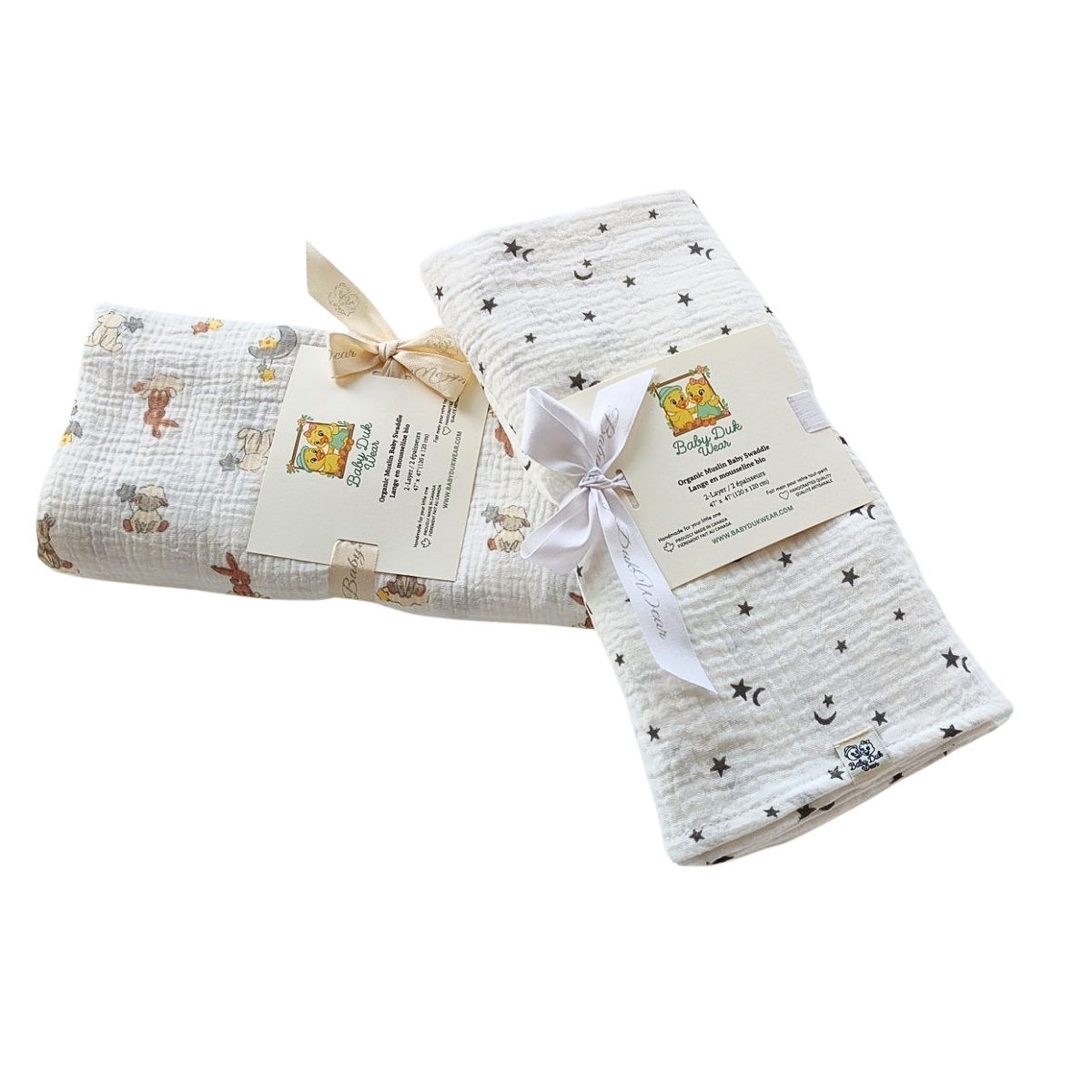 Two folded muslin swaddle blankets from Baby Einstein's 'My First Space & Nature' collection, one with a space-themed star and moon pattern and one with a nature-themed animal print Northern Stars and pattern Dream , both tied with ribbons and attached to product tags.